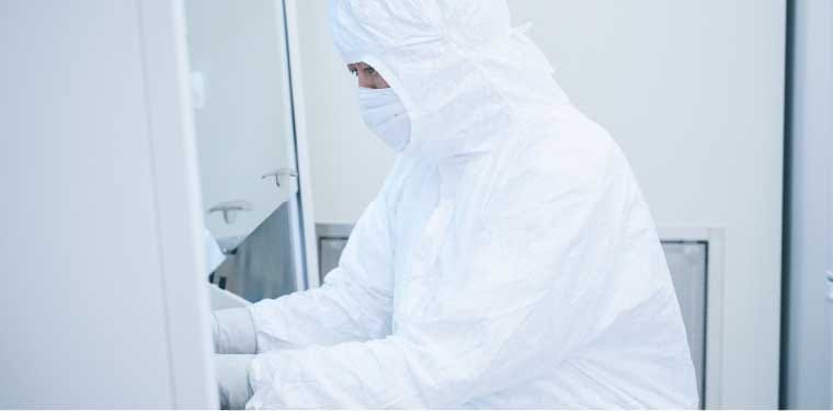 A researcher working in a cell culture room